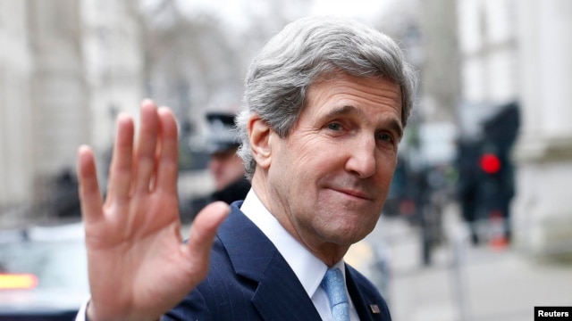U.K. -- U.S. Secretary of State John Kerry waves as he leaves Number 10 Downing Street in London, 25Feb2013