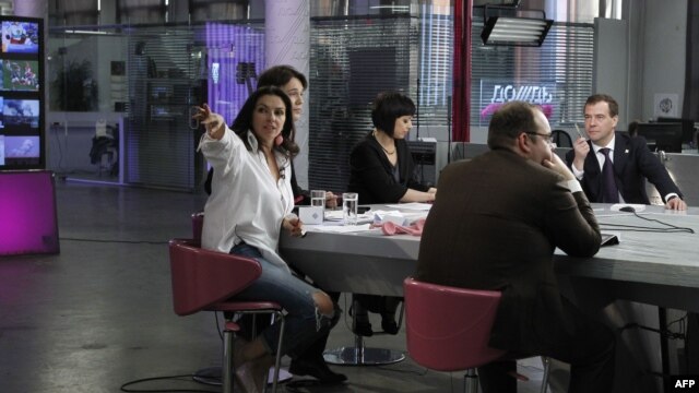 Russia’s President Dmitry Medvedev (far right) visiting the Dozhd TV headquarters in Moscow on April 25, 2011.