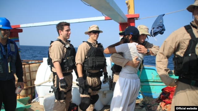A U.S. Navy image of a "USS Kidd" crew member embracing one of the fishermen whose Iranian-flagged "Al Molai" vessel and crew were saved from pirates on January 5 in the northern Arabian Sea.