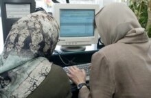 Iran - Two Iranian women work at an internet cafe in Tehran 20Sep2004
