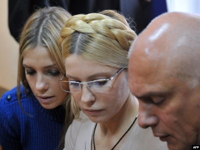 Yulia Tymoshenko (center), her daughter Yevgenia, and her husband, Oleksandr, react after the verdict is announced.