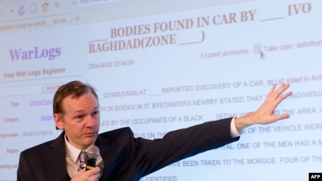 The founder of the WikiLeaks website, Julian Assange, displays a page from the released documents to journalists in London on October 23.
