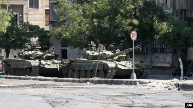 Government tanks in the Midan neighborhood of Damascus on July 20