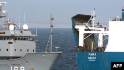 A U.S. Navy ship provides fuel and fresh water to the "Faina" following its release by Somali pirates.