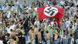 Karpaty Lviv supporters hold up a German Nazi flag at a soccer match against Dynamo Kyiv in 2007.