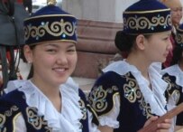 Kyrgyz women in traditional costume at a festival in Bishkek in May (RFE/RL)