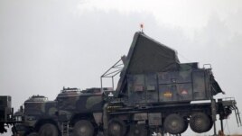German military vehicles carrying equipment for NATO Patriot missiles at a military base in Kahramanmaras, Turkey