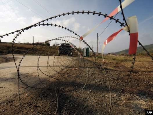 German KFOR troops patrol near the Serb-erected barricade in the village of Zupce on October 26.