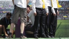 Security guards attend to the wounded trophy. It escaped with minor injuries.