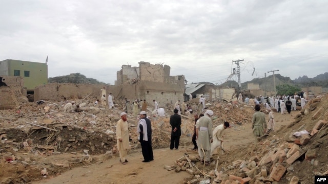 Local residents search for their belongings in the rubble of destroyed houses following a terrorist attack near a police station in the Lakki Marwat district of Khyber Pakhtunkhwa province in 2011.