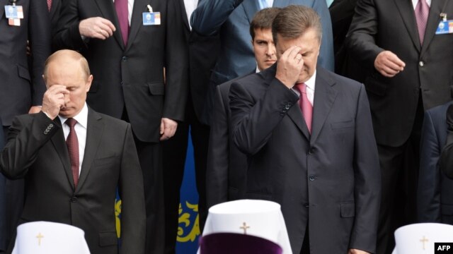 Russian President Vladimir Putin and former Ukrainian President Viktor Yanukovych during a 2013 ceremony in Kyiv marking the 1,025th anniversary of Christianity of Kievan Rus.