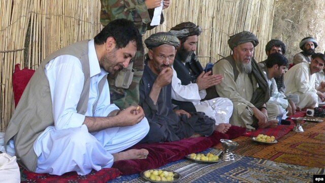 Asadullah Khalid (left) meets with journalists and local elders during his time as governor of Kandahar Province in 2008.