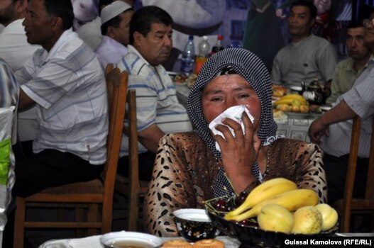 An Osh woman who lost her grandchild, son, and daughter during ethnic violence in June 2010 mourns at the commemoration ceremony on June 10.