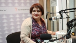 Female reporter sitting in radio studio