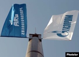The flags of the ARG national gas operator and its dominant Russian shareholder, Gazprom (file photo)