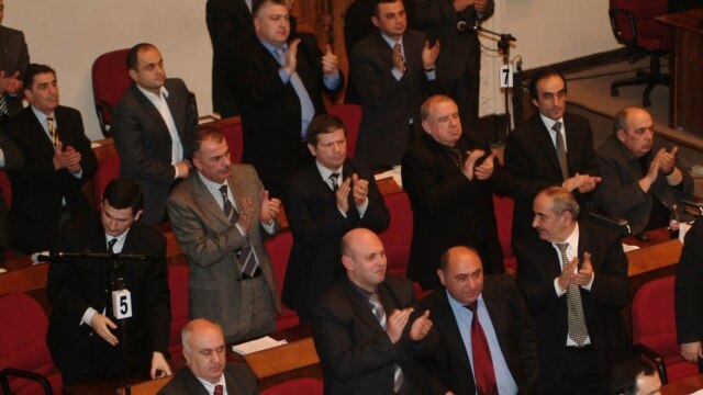 Georgian deputies applauding parliament's decision on 14 February (AFP)