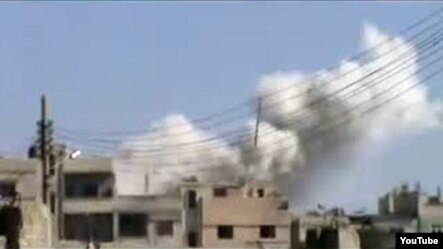 A screen grab from a YouTube video purporting to show smoke rising from buildings in the Baba Amr neighborhood of Homs on February 5.