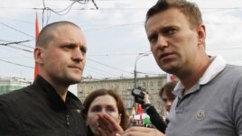 Sergei Udaltsov (left) and Aleksei Navalny speak at the May 6 opposition rally.