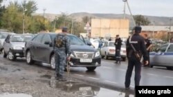 Security forces attend the scene of a bomb attack at a police station in Chechnya on September 16 that killed three people.