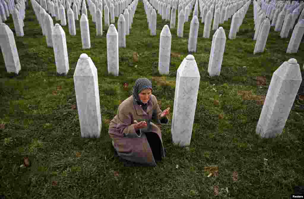 Bida Smajlovic prays near the graves of her husband and brother in Potocari, near Srebrenica, before watching the war-crimes trial of former Bosnian Serb leader Radovan Karadzic in The Hague. Bida lost her husband and brother and dozens of other members of her family in the war. (Reuters/Dado Ruvic)