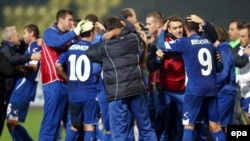 Bosnia-Herzegovina's squad and coaches celebrate qualifying for next year's soccer World Cup after beating Lithuania in October. It will be the first time the Balkan country will be competing at football's blue riband event.