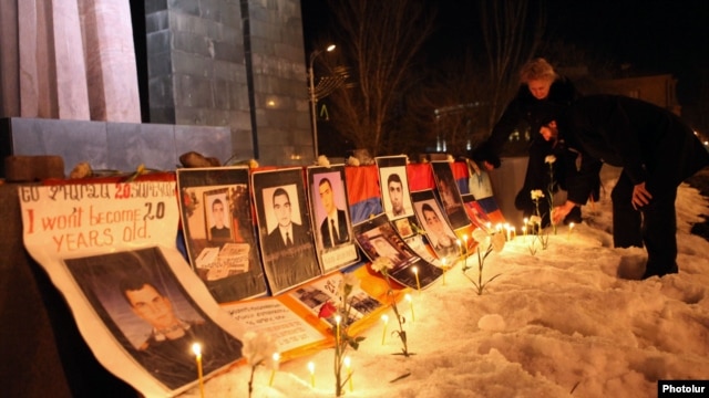 Pictures of opposition supporters killed in Yerevan in March 2008 are placed at the site of the deadly postelection unrest in March 2012. Opposition parties will watch for a clean vote.