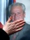 A supporter of former Serbian leader Slobodan Milosevic touches his portrait in front of the Belgrade offices of his party, the Socialist Party of Serbia (epa)