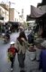 A woman, fully veiled, walks down a street with her son.