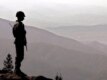 A Pakistani Army soldier looks out over the rugged Afghan-Pakistani border from the Pakistani tribal belt