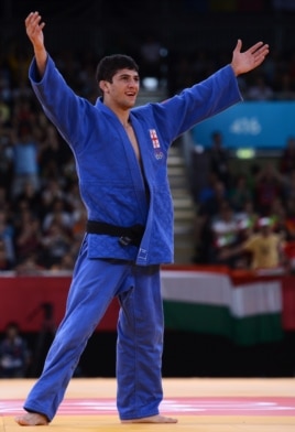 Lasha Shavdatuashvili celebrates after beating Hungary's Miklos Ungvari on July 29.