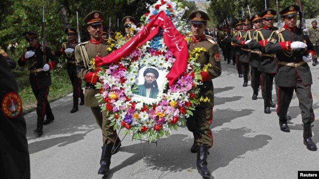 Soldiers carry wreaths and a portrait of Arsala Rahmani, a senior member of the High Peace Council who was assassinated by Afghan insurgents earlier this month.