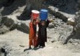 Afghan children carry water to their homes in Kabul (epa)