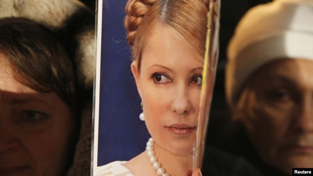Supporters of opposition parties hold up a portrait of jailed former Prime Minister Yulia Tymoshenko in Kyiv on November 12.