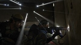 Syria -- Two rebels take sniper positions at the heavily contested neighborhood of Karmal Jabl in central Aleppo, 18Oct2012