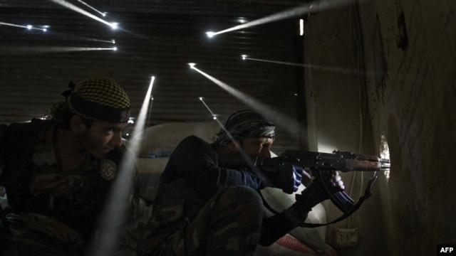 Syria -- Two rebels take sniper positions at the heavily contested neighborhood of Karmal Jabl in central Aleppo, 18Oct2012