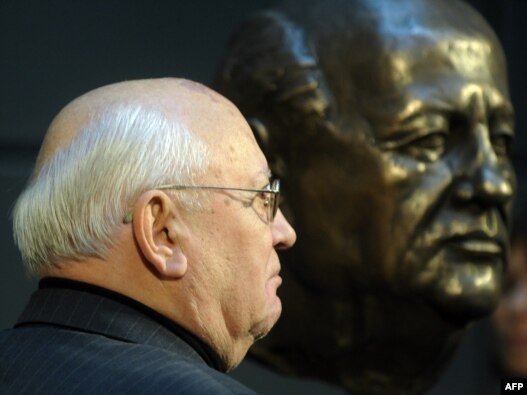 Mikhail Gorbachev stands next to a bust of himself after unveiling it in Berlin in November 2009.