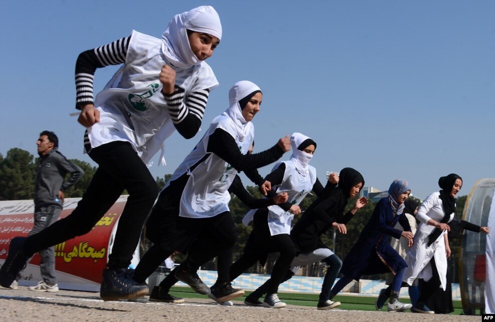 Afghan schoolgirls take part in a running race held for a peace initiative in the western Herat Province. (AFP/Aref Karimi)