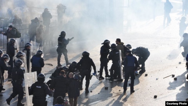 Kosovo-Albanian protesters clash with police near the Serbian border. 