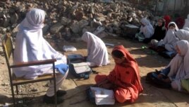 Girls sit amid the rubble of their destroyed school near the Afghan border, which was allegedly bombed by the Taliban militants in Bajaur in April.