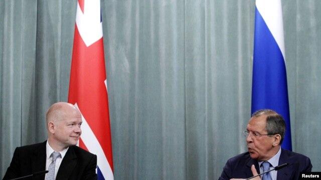 U.K. Foreign Secretary William Hague (left) has told Russian Foreign Minister Sergei Lavrov that all defense shipments to Syria must stop.