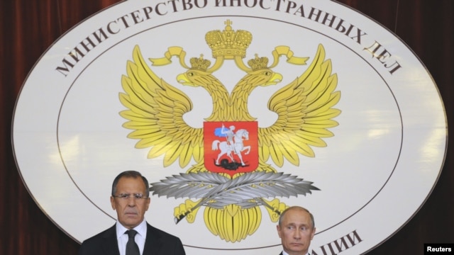 Russia -- President Vladimir Putin (R) and Foreign Minister Sergei Lavrov attend a meeting with Russian ambassadors at the Foreign Ministry headquarters in Moscow, 09Jul2012