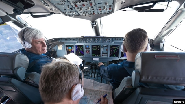 Sukhoi's chief civil test pilot, Aleksandr Yablontsev (left), and his crew sit in the cockpit of a Sukhoi Superjet during a flight on May 8, one day before the deadly crash in Indonesia.
