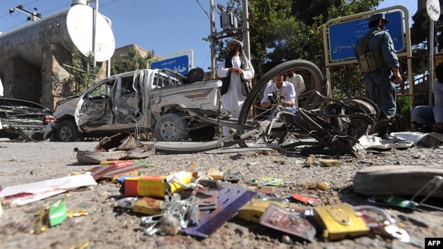 Locals inspect the site of a bomb explosion in Herat on August 15.