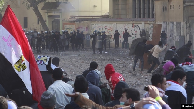 Protesters and riot police face off near Tahrir Square in Cairo on November 21.
