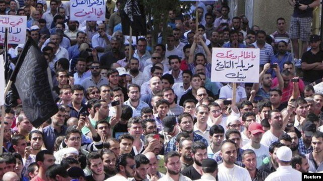 Kurdish antigovernment demonstrators march through the streets in the Syrian town of Qamishli in October.