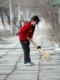 A girl sweeps sidewalks in Kyrgyzstan (RFE/RL)