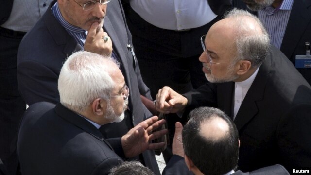 IIranian Foreign Minister Mohammad Javad Zarif (left) and head of the Atomic Energy Organization of Iran Ali Akbar Salehi (right) appear to have an intense discussion on the sidelines of negotiations with U.S. Secretary of State John Kerry over Tehran's nuclear program in Lausanne, Switzerland.