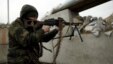 A militant fighting for Russia-backed separatist forces aims his weapon at a checkpoint at the front line with Ukrainian armed forces near the town of Avdiivka, outside Donetsk, on March 17.