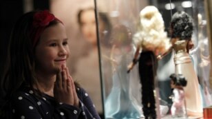 A girl looks at Barbie dolls during a Barbie exhibition in Zagreb on May 15.