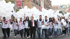 Armenia - A senior member of the ruling Republican Party escorts young party activists to an election campaign rally in Yerevan's Republic Square, 4May2012.